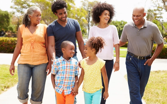 a happy, multi-generational family walking together, representing community-focused wellness.
