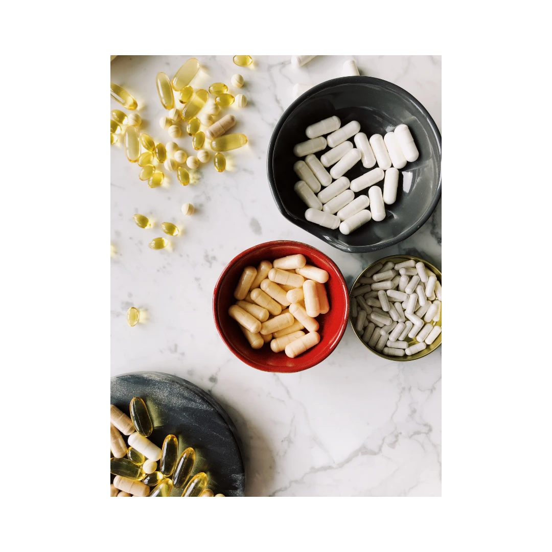 various health supplements in bowls, representing customized integrative nutrition plans.